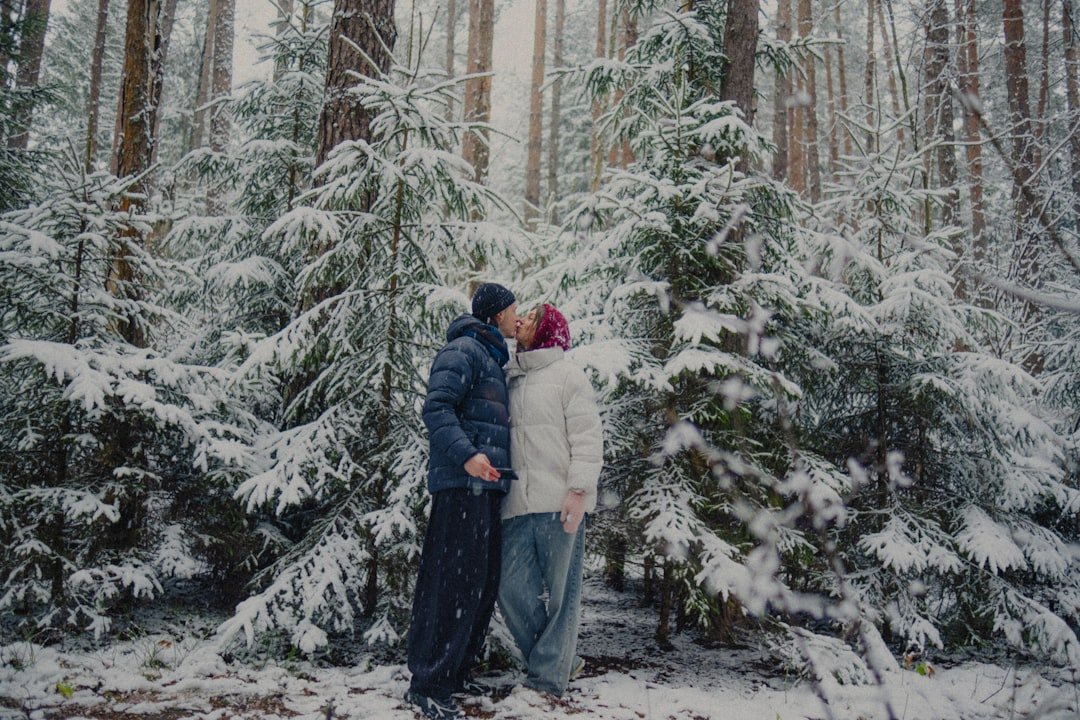 Couple sharing a playful winter kiss