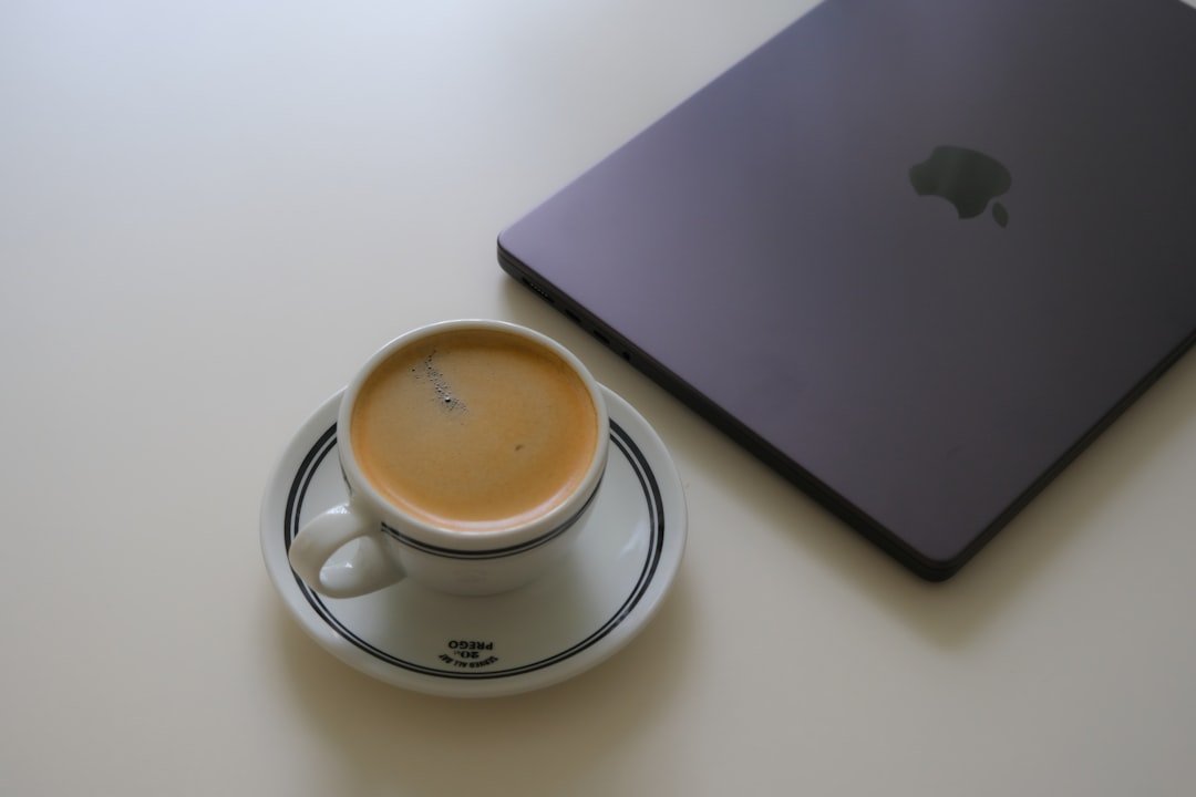 Espresso cup next to a laptop, a small everyday FML moment