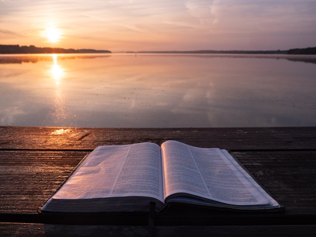 Peaceful sunrise with open Bible for Wednesday prayer