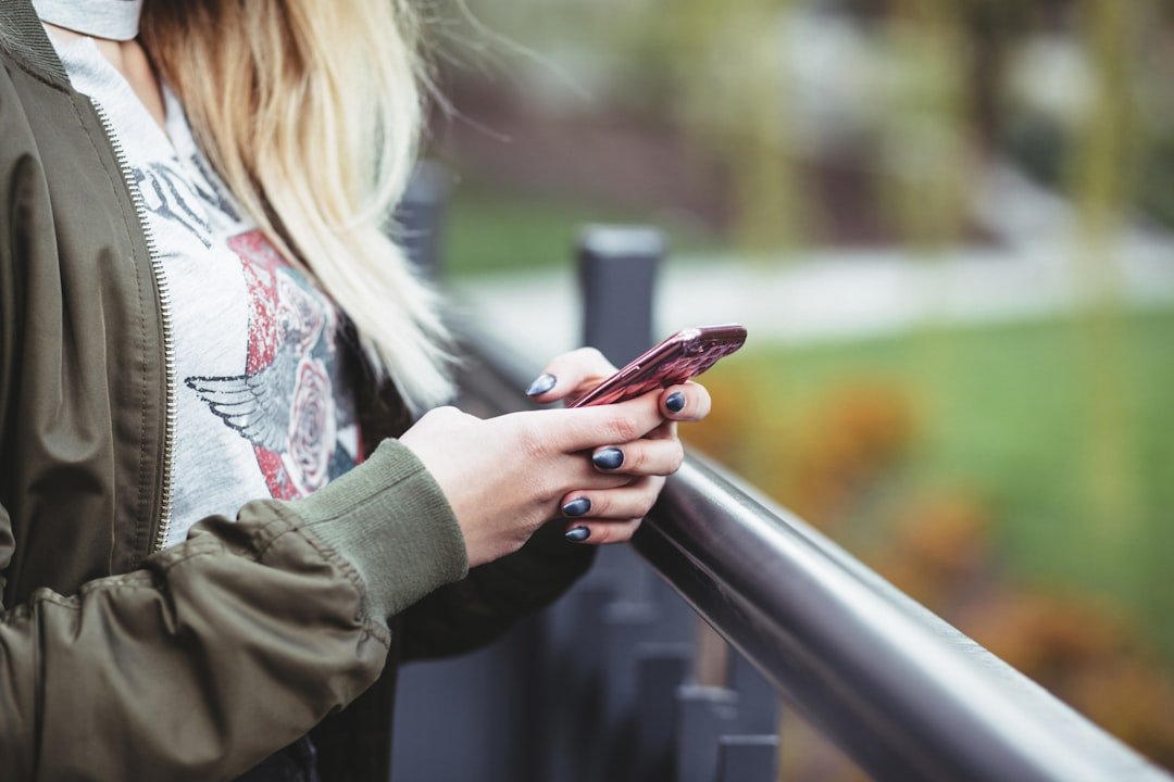 Woman holding phone, texting ICL meaning honest opinion
